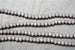 String of 3 x 4 mm opaque grey faceted glass rondel beads.